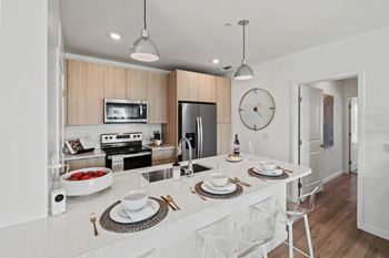 an open kitchen with a large counter top and a sink at Altis Grand Suncoast, Florida, 34638